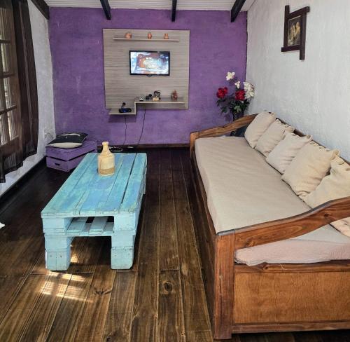 a bedroom with a bed and a blue table at Piccolo Paradiso in La Pedrera