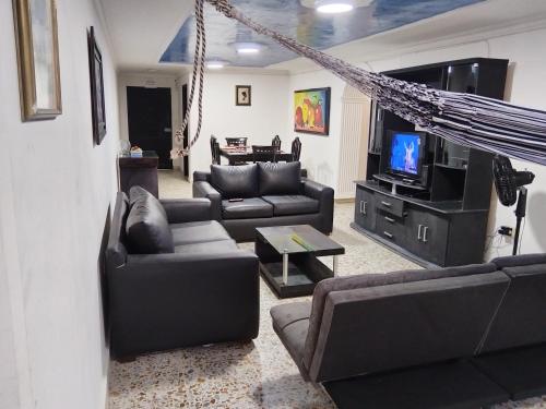 a living room with couches and a flat screen tv at Apartamento Edificio Mara Rodadero in Rodadero