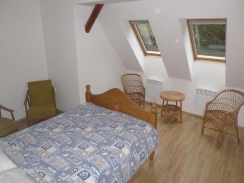 a bedroom with a bed and a table and chairs at Holiday Home Rudník near Ski Lift in Javorník