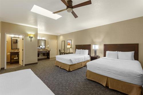 a hotel room with two beds and a ceiling fan at Best Western Plus Canyonlands Inn in Moab