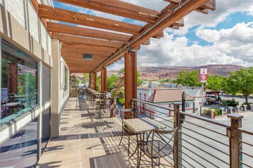 a balcony with tables and chairs on a building at Best Western Plus Canyonlands Inn in Moab
