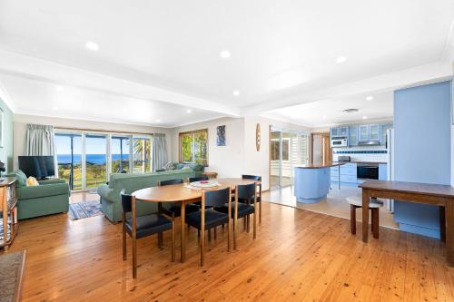 a kitchen and living room with a table and chairs at The Palms Mystery Bay in Mystery Bay