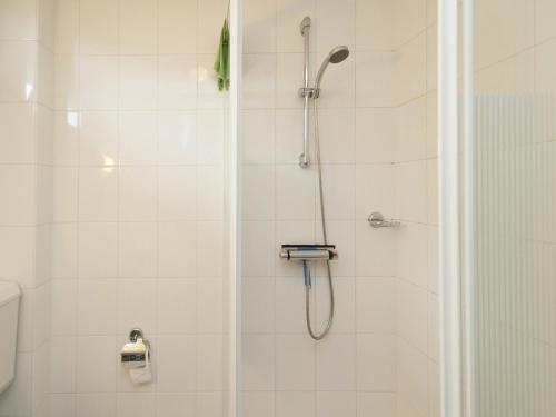 a bathroom with a shower with a glass door at Holiday Home in Schoorl near Dunes in Schoorl