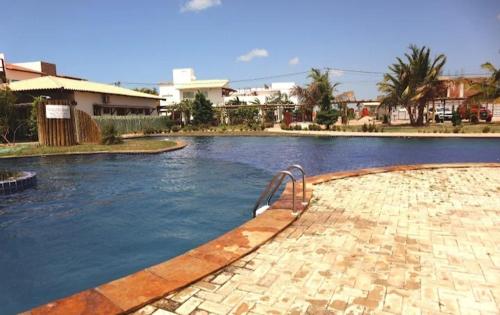a swimming pool with a metal railing in the middle at Pousada Village Gostoso in São Miguel do Gostoso