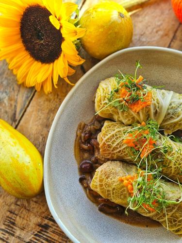 a plate of food on a table with a sunflower at Hotel Bardo in Bardo