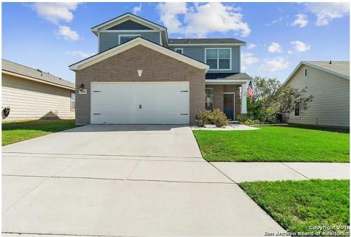 a house with a large garage in the driveway at Military PCS Training RBAFB FSAB in San Antonio
