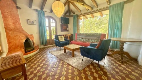a living room with a couch and chairs and a table at INTIYAYA - Boutique Lodge in Otavalo