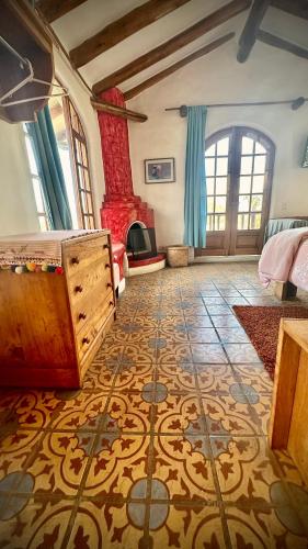 a bedroom with a bed and a fireplace in a room at INTIYAYA - Boutique Lodge in Otavalo