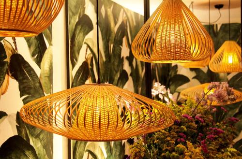 a group of lights hanging from a wall with flowers at Botanic Home in Marbella