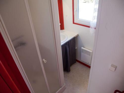 a small bathroom with a sink and a white sink at Chalet cosy avec terrasse pour 2 pers. à Naucelle - API-1-52-334 in Naucelle