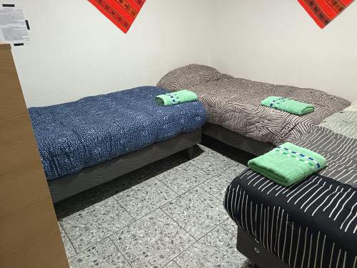 two beds and a couch in a room at Misky Wasi in San Pedro de Atacama
