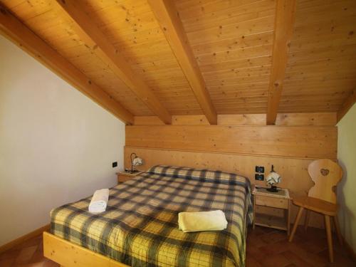 a bedroom with a bed and a wooden ceiling at Holiday Home in Caldes near Ski Lift in Caldes