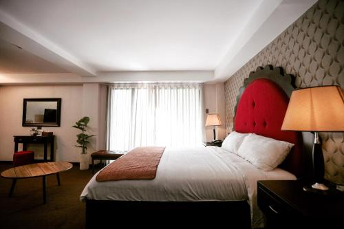 a hotel room with a large bed and a window at Amega Hotel in Tagaytay
