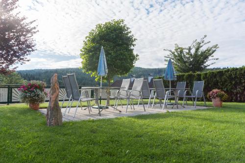 a group of chairs and umbrellas on a patio at Florianihof in Miesenbach