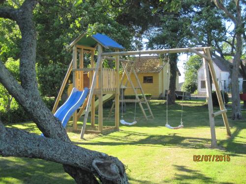 a playground with a slide in a yard at Nygammelsø Bed & Breakfast in Stege