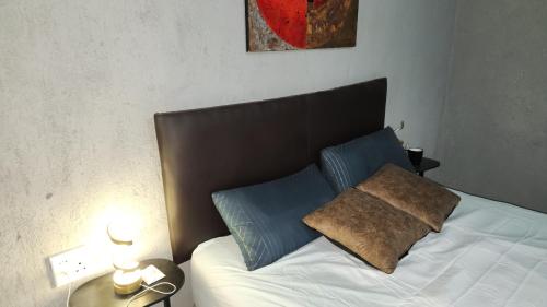 a bed with two pillows on it in a bedroom at GenAyah Hotel & Safari in Mtimba