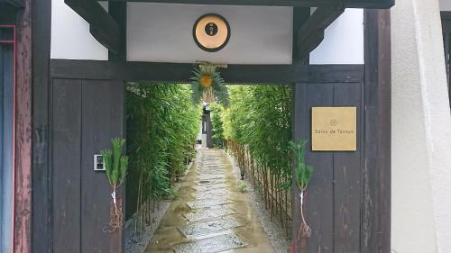 a door to a building with plants on it at Ryokan Tanoya in Kyoto