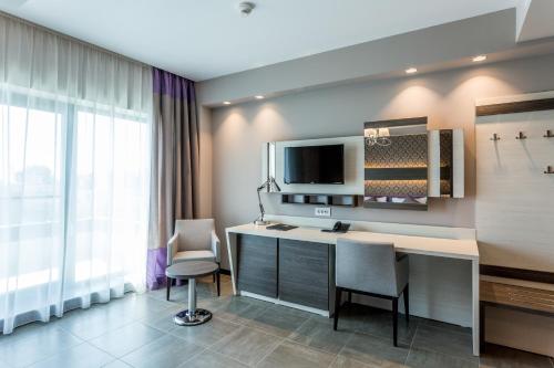 a hotel room with a desk and two chairs at New Splendid Hotel & Spa - Adults Only (+16) in Mamaia