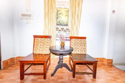 a dining room with a table and two chairs at Nirasim Villa in Luang Prabang