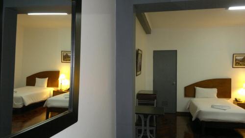 a mirror in a hotel room with two beds at Suites Larco 656 Miraflores Lima in Lima
