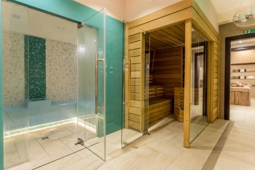 W łazience znajduje się prysznic i przeszklona kabina prysznicowa. w obiekcie New Splendid Hotel & Spa - Adults Only (+16) w Mamai