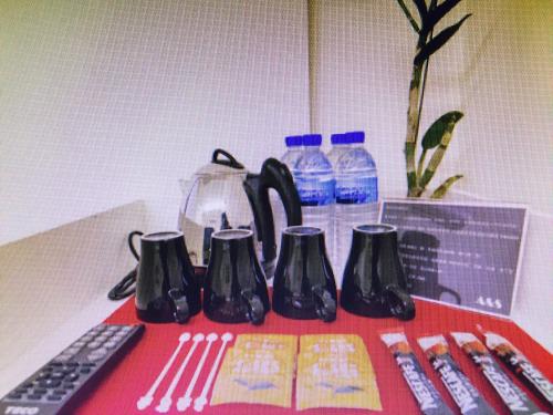 a table with a remote control and some bottles of water at Kenting A&S in Hengchun