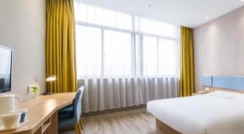 a hotel room with a bed and a desk and window at Home Inn Neo Zhuji Zhejiang Agriculture and Forestry University in Shaoxing