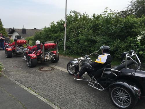 a group of people riding motorcycles and a car at Hotel Del Sol in Bad Wildungen