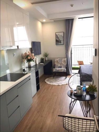 a kitchen and a living room with a table at 5 Star Apt Studio, Swimming Pool, Gyms, Quick To Airport in Hanoi