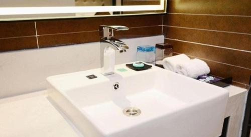 a bathroom sink with a faucet on top of it at Xana Hotelle Xi'an Zhonglou, Huimin Street Metro Station in Xi'an