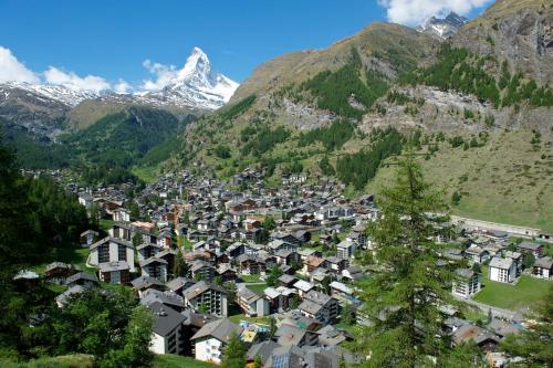 a town in the mountains with a snow covered mountain at Hotel Garni Testa Grigia in Zermatt