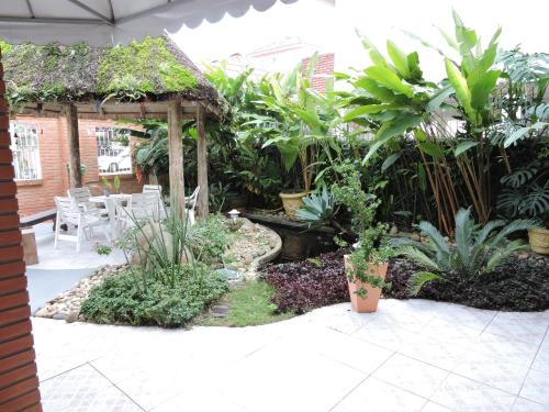 a garden with a gazebo and plants at Pousada Don Alberto's in Florianópolis