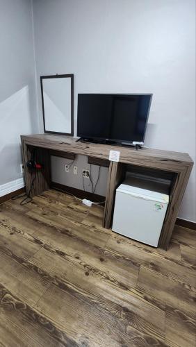 a wooden desk with a television on top of it at Hue Stay in Busan