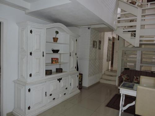 a room with white cabinets and a staircase at Pousada Don Alberto's in Florianópolis