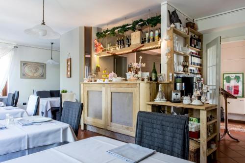 a restaurant with tables and chairs and a bar at Hotel Florence in Manerba del Garda