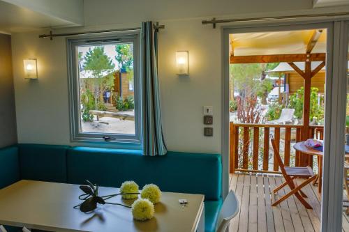 a room with a table and a window at Vic's Land Holidays in Grimaud