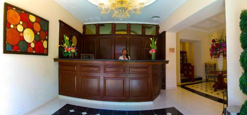 a large room with a large mirror and a clock on the wall at Hotel Plaza Colonial in Campeche
