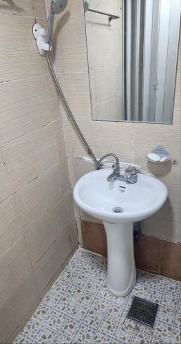 a bathroom with a white sink and a mirror at Time Stay in Busan