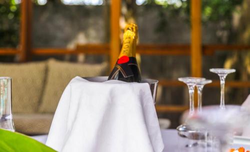 a bottle of champagne sitting on a table at Boutique Hotel Particulier in Abidjan