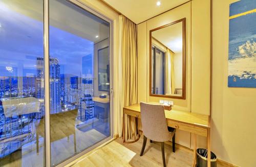 a home office with a desk and a large window at S79 Residence LYN Panorama in Nha Trang