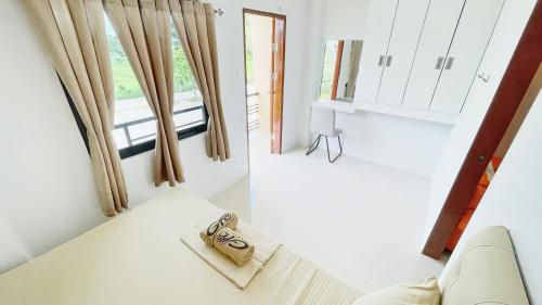 a pair of keys sitting on a bed in a room at GTC Apartelle - Tacloban in Tacloban