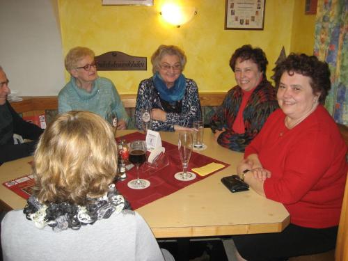 a group of people sitting around a table with wine glasses at Gasthof Maly in Mauthausen