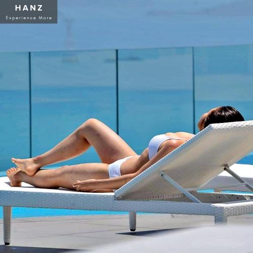 a woman laying on a chair in a swimming pool at S79 Residence LYN Panorama in Nha Trang
