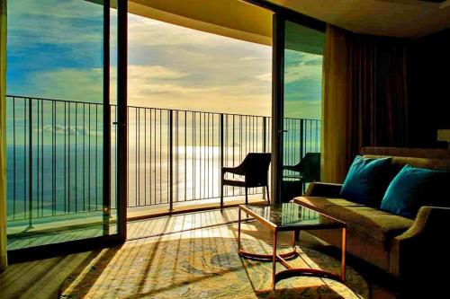a living room with a couch and a glass table at S79 Residence LYN Panorama in Nha Trang