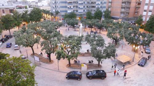 a park with cars parked in a courtyard with trees at Cairoli Exclusive Rooms & Suite in Brindisi