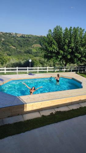 two people swimming in a swimming pool at Za Teresa - Napoleonic Private Resort & Spa - Entire property only in Giuliano Teatino