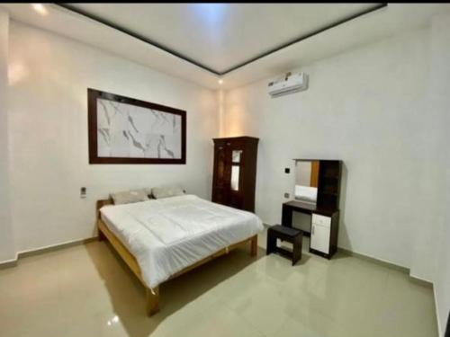 a bedroom with a bed and a desk in it at Gareka villa in Amed