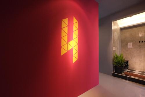 a red wall with a yellow x on it at Everyday Bangkok Hostel in Bangkok