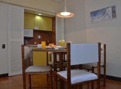 a kitchen with a table and chairs in a room at Edificio Corrientes 1856 in Buenos Aires
