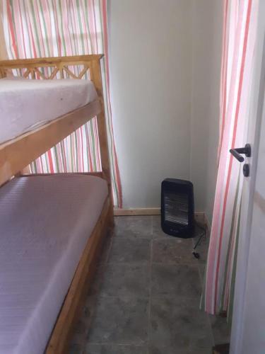 a room with two bunk beds and a sign on the floor at Limones in Mariano Moreno